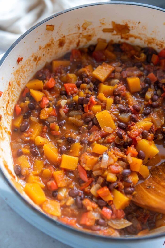 Butternut squash chili with black beans cooking in a large soup pot.
