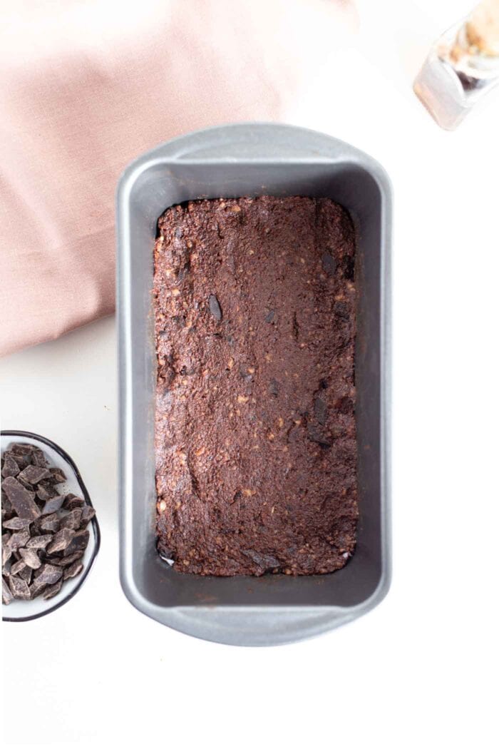 Raw brownies in a loaf pan.