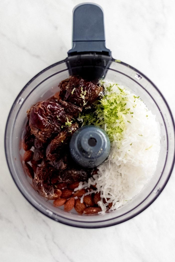 Dates, coconut and lime in a food processor.