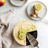 Two small plates with slices of no-bake mango cheesecake with lime.