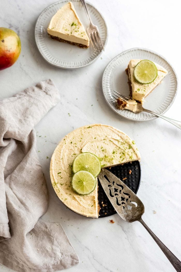 Two small plates with slices of no-bake mango cheesecake with lime.