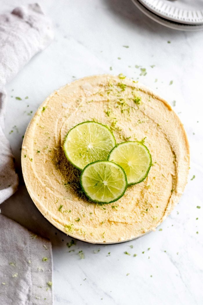 Overhead shot of a no-bake mango cheesecake with lime.