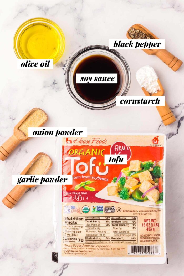 All the ingredients for making crispy oven baked tofu with garlic powder, onion powder, soy sauce and cornstarch.