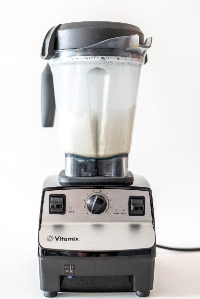 Vitamix blender with blended hemp milk in it.