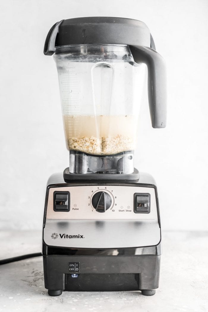 Oats and water in a Vitamix ready to make easy homemade oat milk.