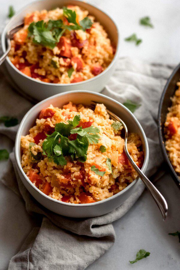 Low-carb vegan Thai red curry cauliflower rice with peas and cilantro.