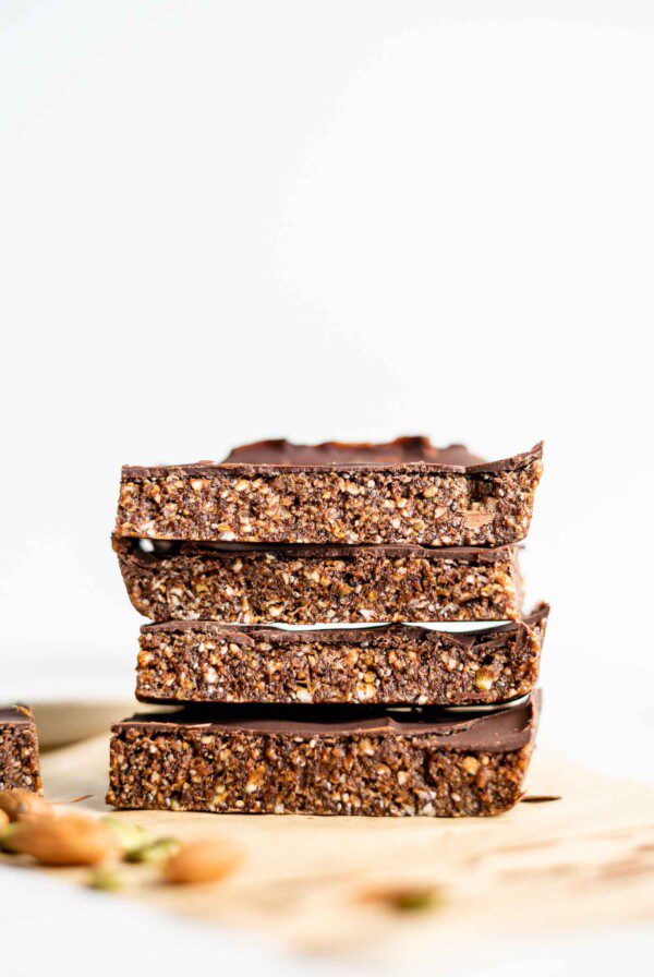 A stack of 4 large energy bars sitting on parchment paper.