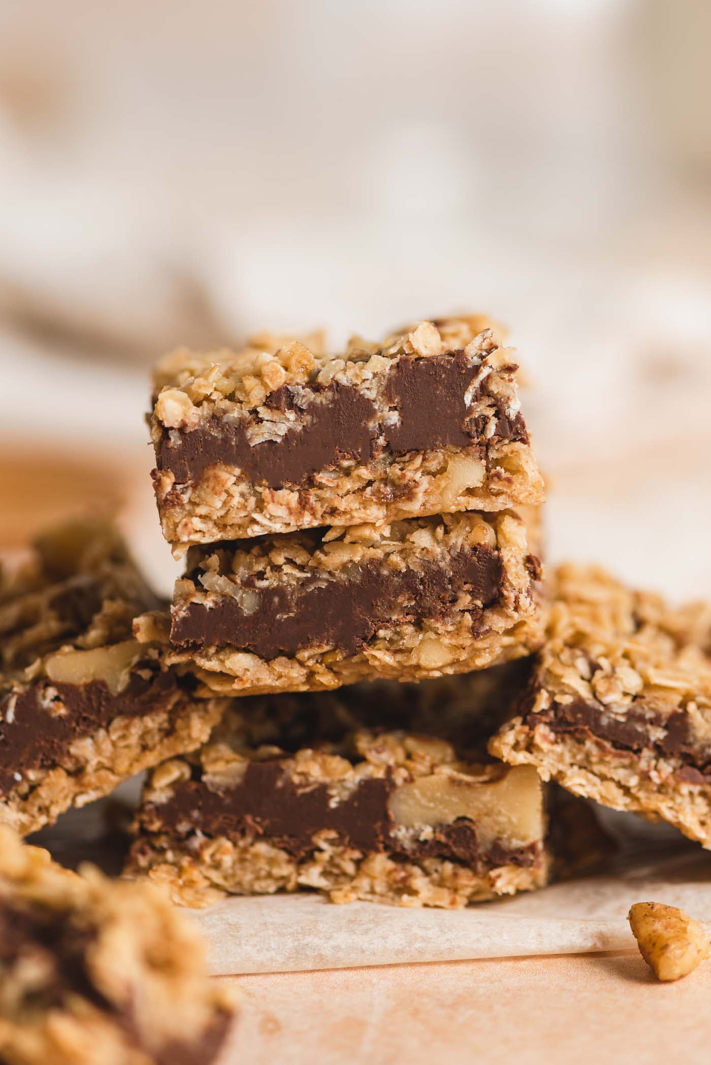 A stack of 3 Starbucks-copycat oat fudge bars with layers of chocolate fudge between layers of oat crust and crumble.