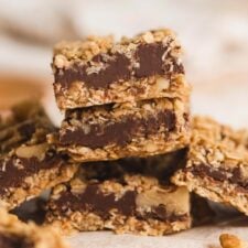 A stack of 3 Starbucks-copycat oat fudge bars with layers of chocolate fudge between layers of oat crust and crumble.