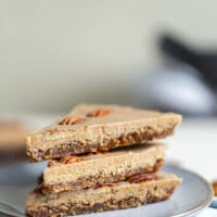 3 slices of raw vegan maple pecan pie on a small grey plate.