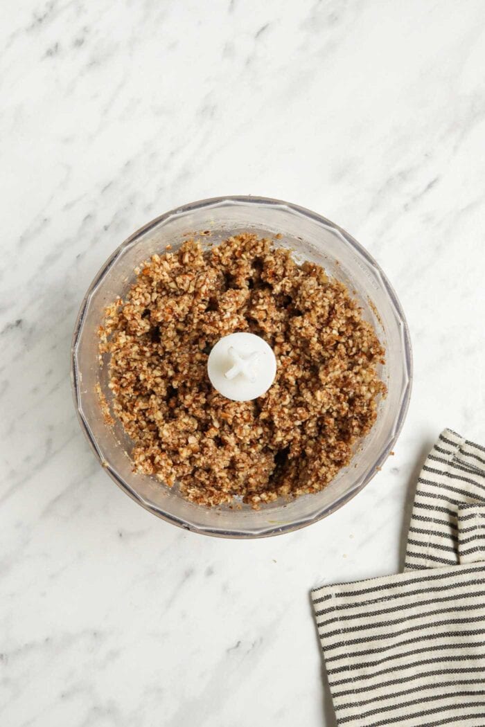 Crumbly pecan dough blended together in a food processor.