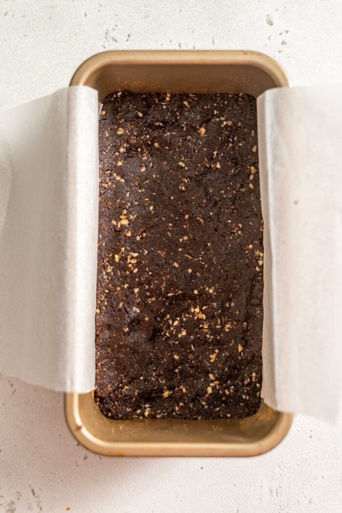 Crust for Nanaimo Bars in a loaf pan.