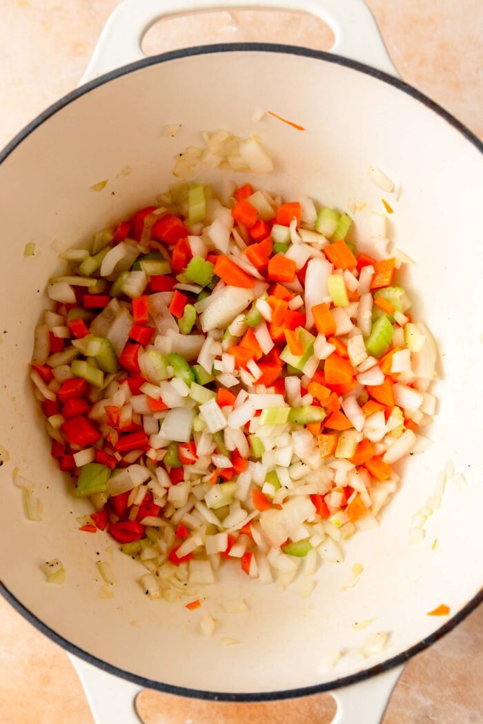 Celery, onion and carrot cooking in a large pot.