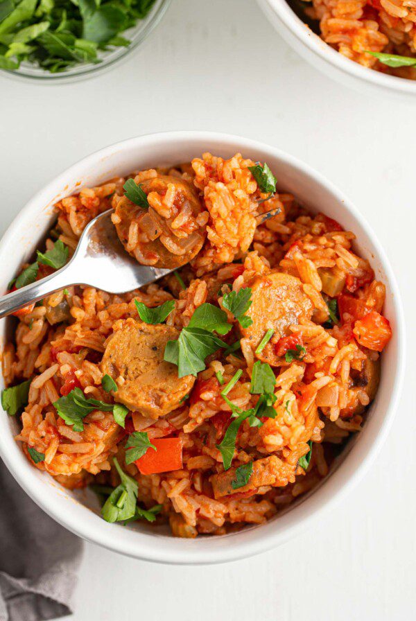Overhead view of a bowl of jambalaya topped with a bit of fresh parsley.