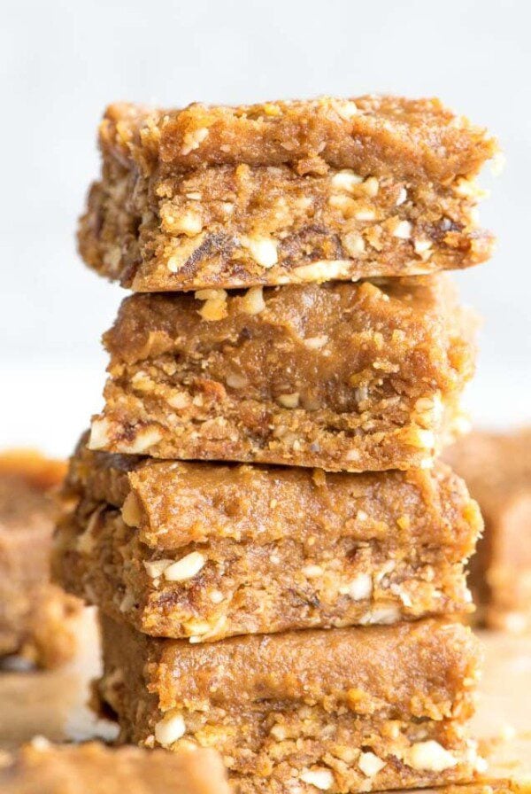 Close up of a stack of 4 peanut butter dessert bars topped with a thick layer of peanut butter frosting.