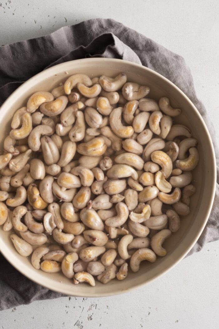 Cashews soaking in a bowl of water.