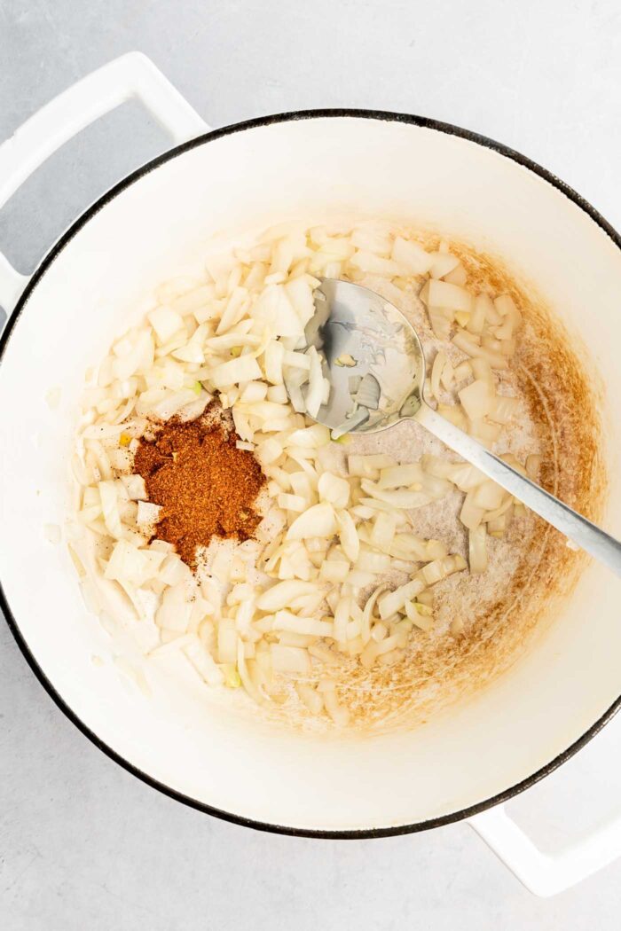 Garlic, onion and cajun seasoning cooking in a large soup pot.